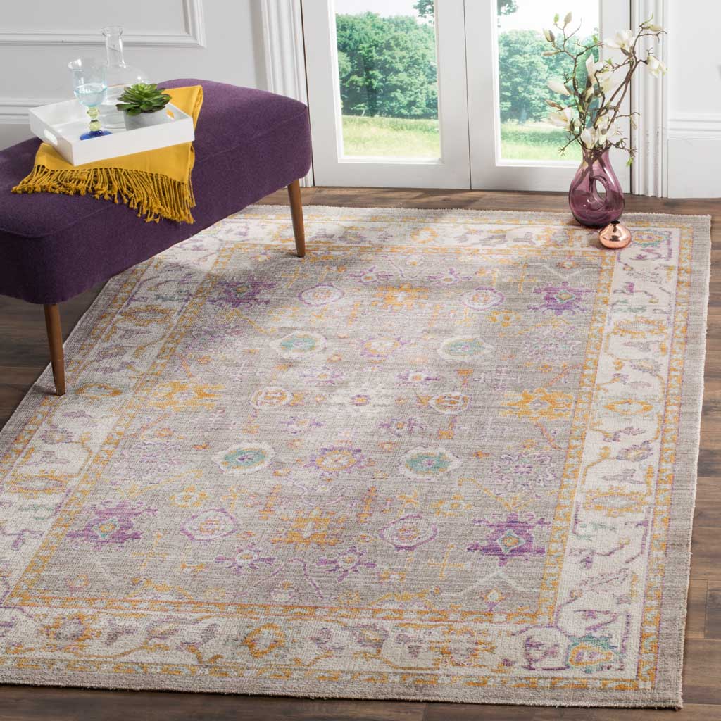 Gray and cream florals with subtle color accents give this area rug a vintage-inspired look