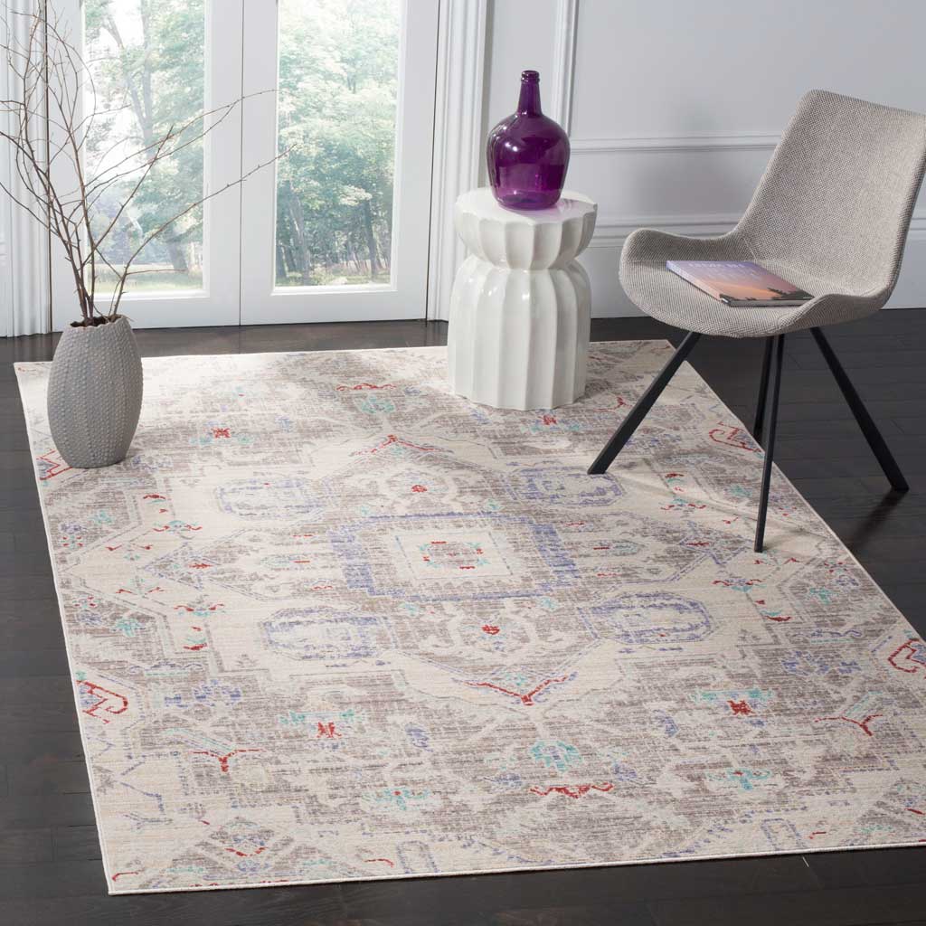 An ivory and light gray medallion rug adds subtle color and traditional detail beneath modern seating.