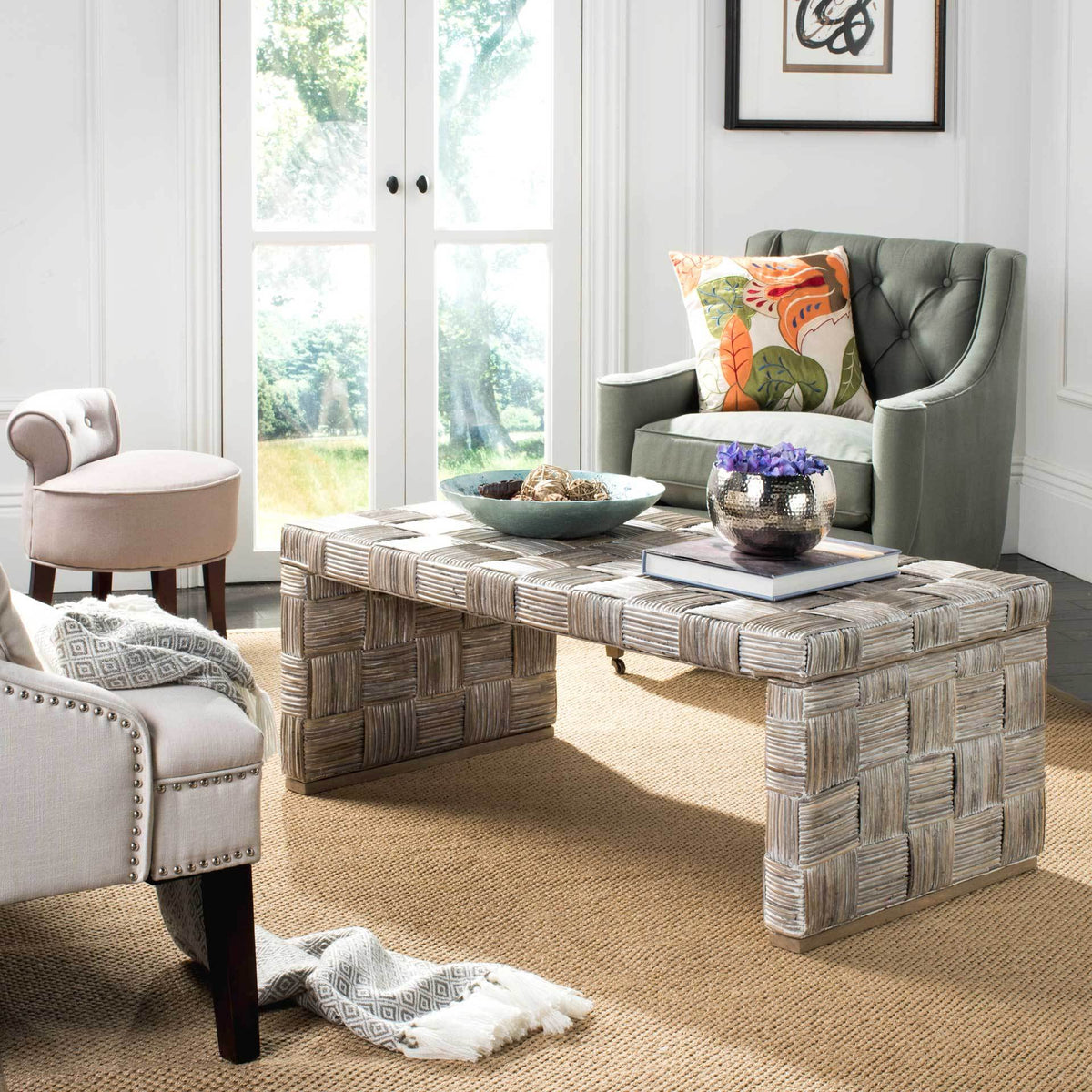Whitewashed woven rattan coffee table adds texture beside upholstered seating