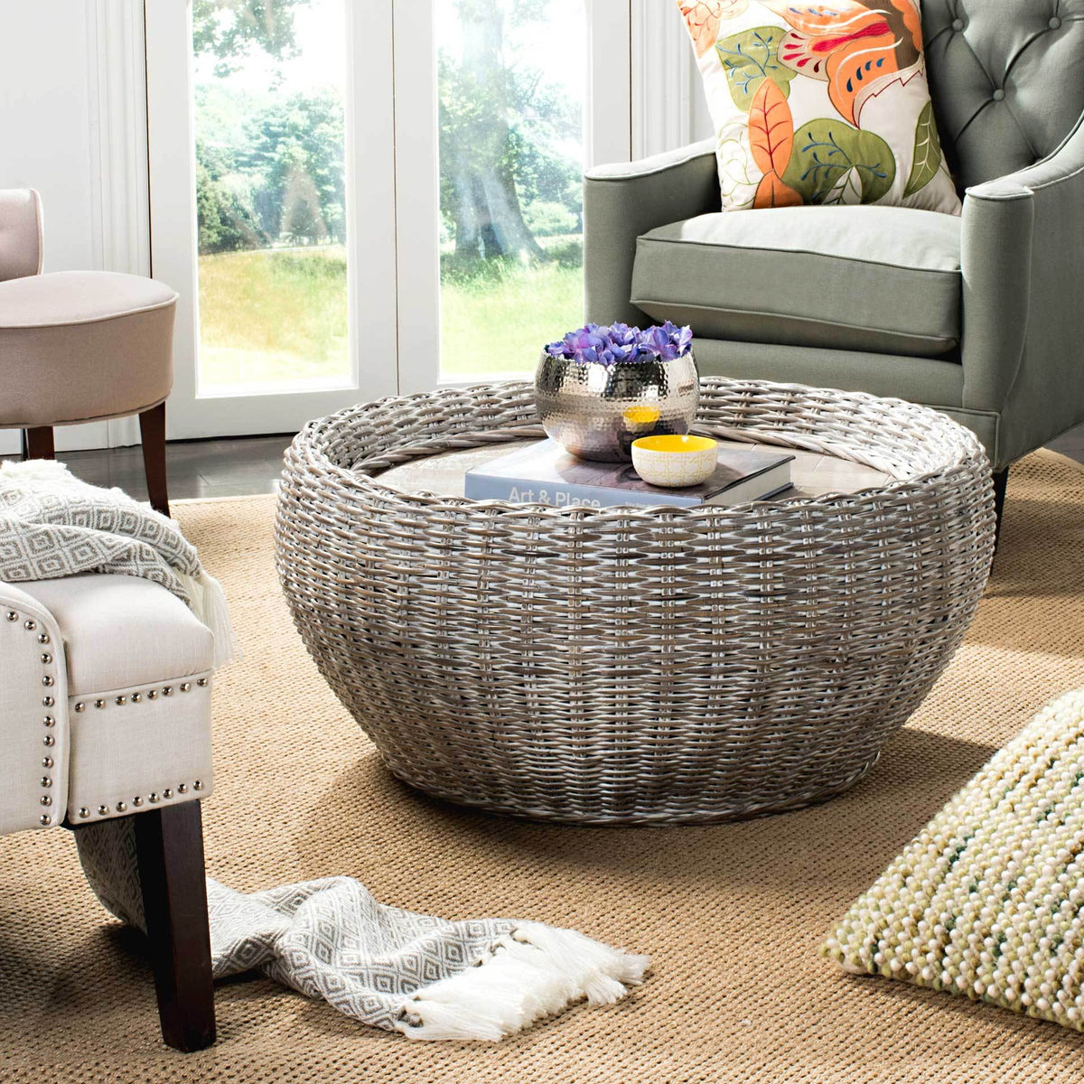 A pale woven coffee table pairs a broad wood surface with a raised basket-style rim.