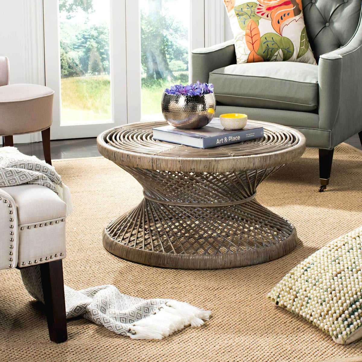 Whitewashed woven rattan and a sculptural base add natural texture to a seating area