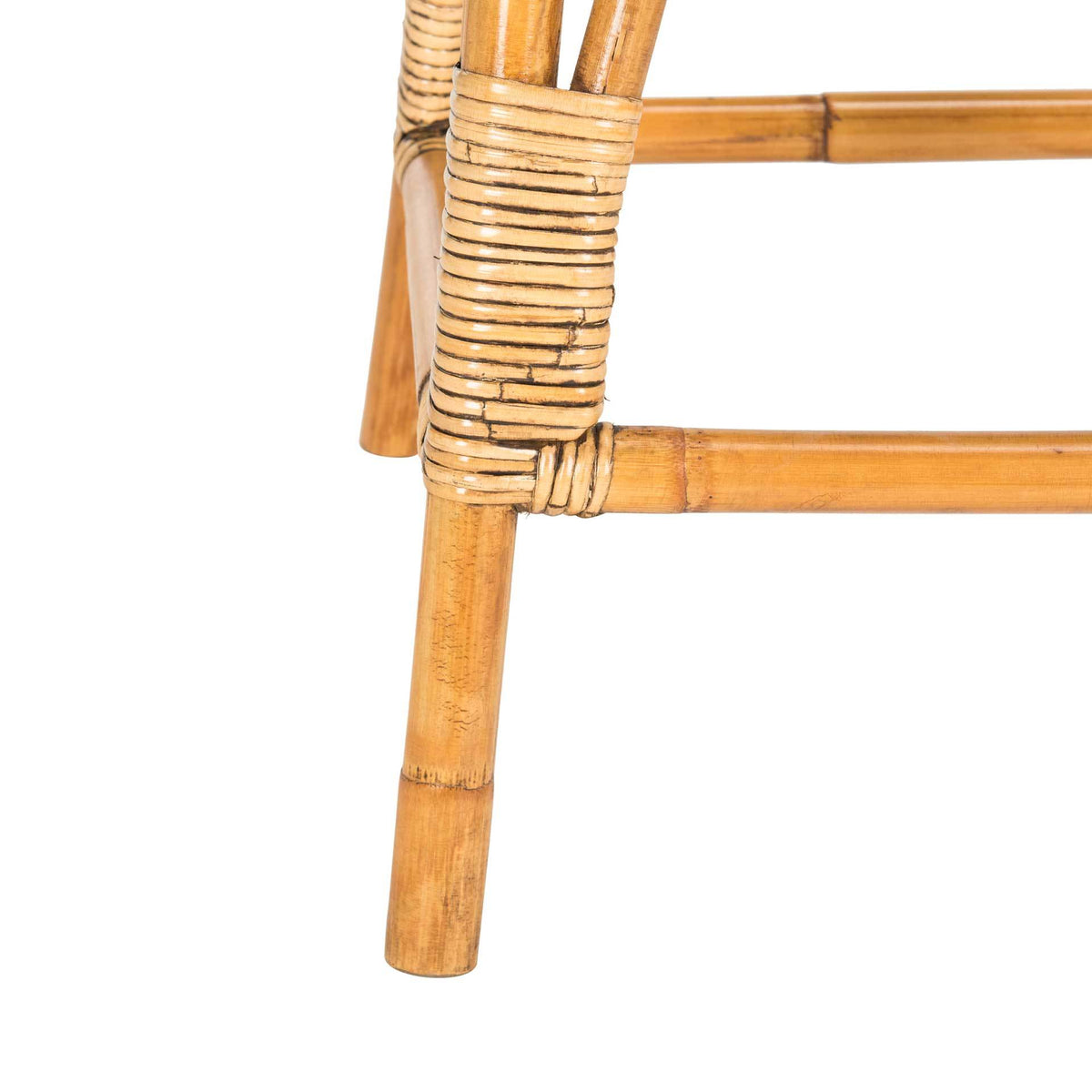 Honey-brown counter stool leg and low footrest meet at a tightly woven rattan joint
