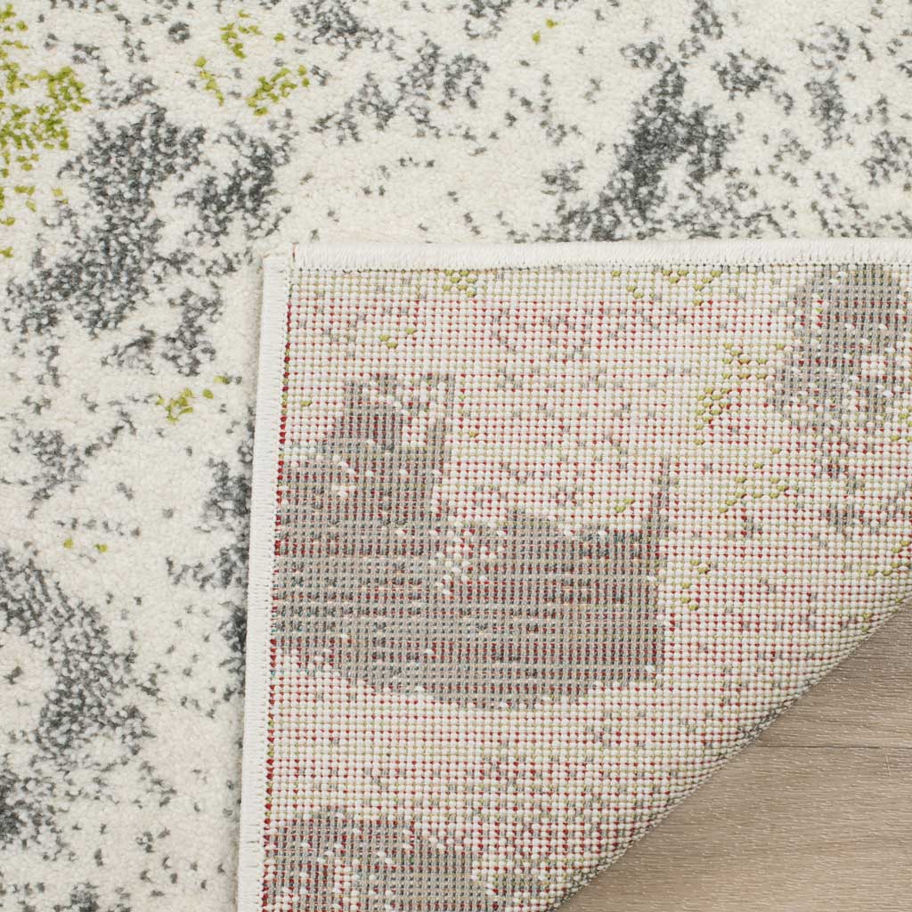 A closely woven underside and neat edging complement the ivory rug's gray-flecked pile.