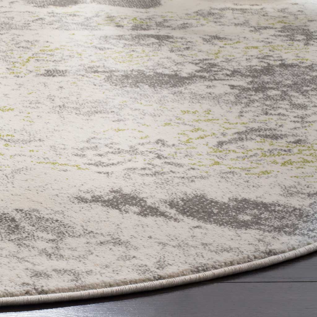 Mottled gray and faint green accents cross the ivory pile and neatly bound edge