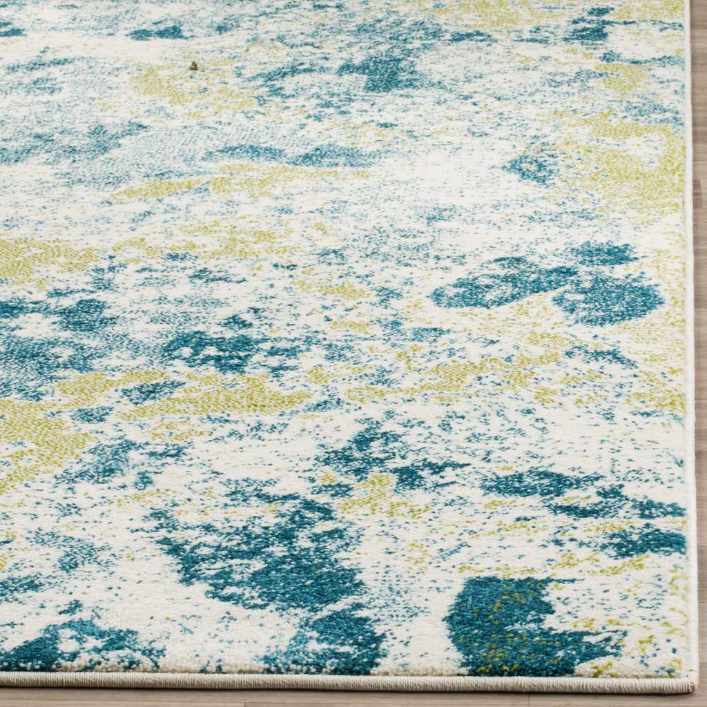 Blue and golden flecks scatter over the ivory pile, finished with a tidy bound edge.