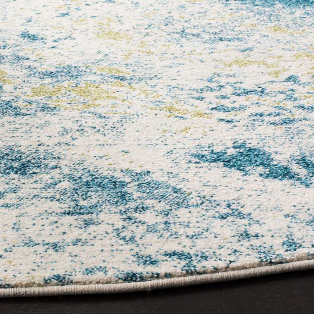 Fine blue and gold speckles brighten the ivory pile above a bound curved edge