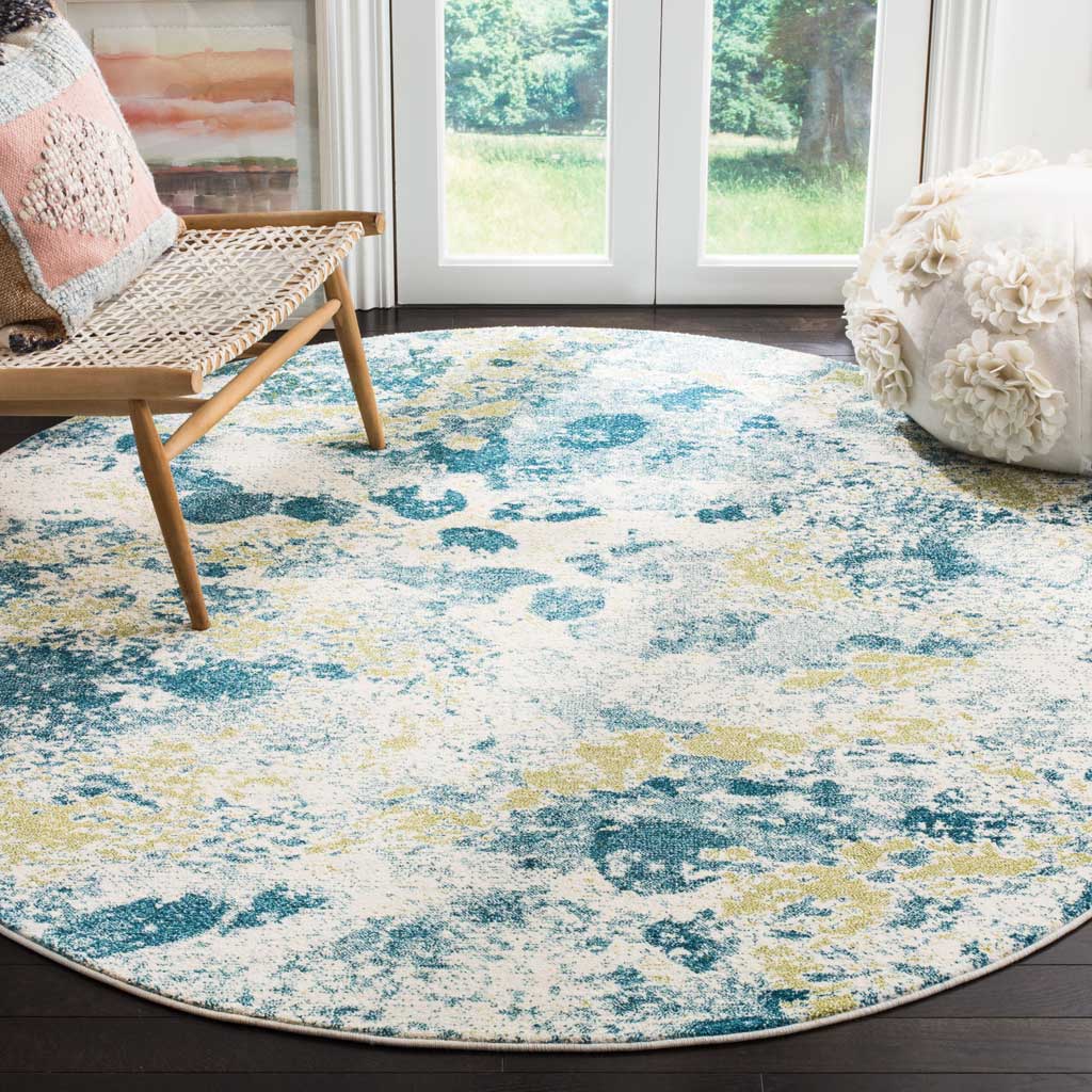 Round ivory and blue rug brings soft color to dark wood floors beside a woven chair