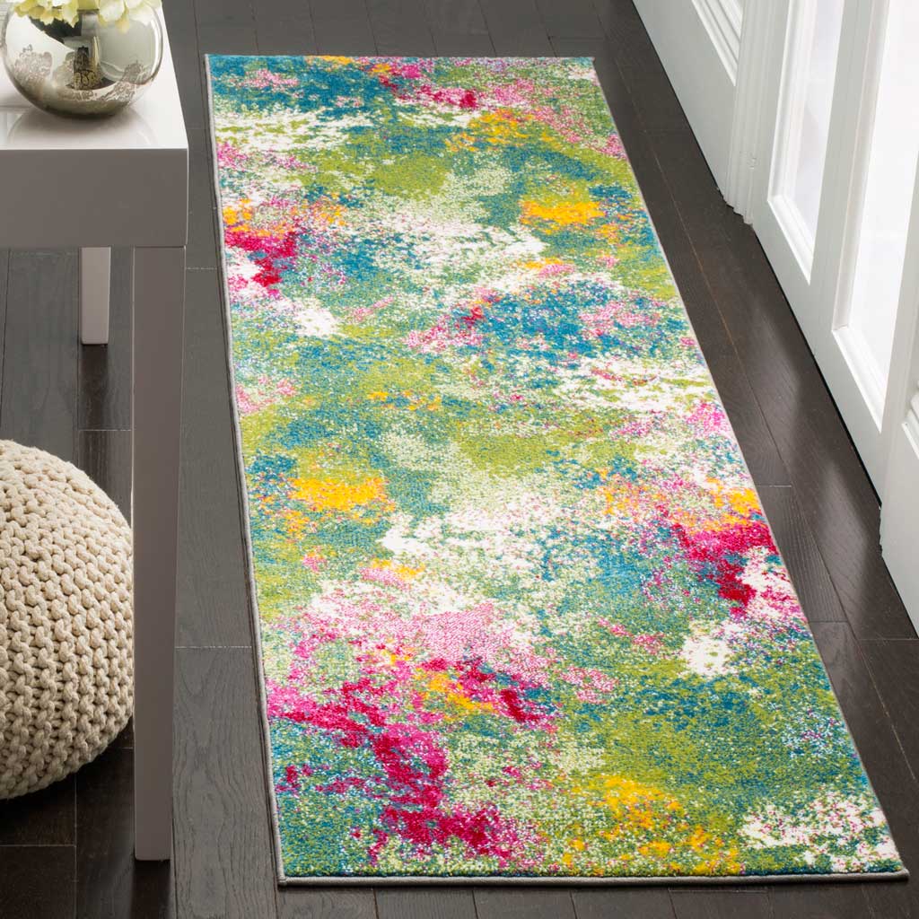Colorful abstract runner adds green, fuchsia and yellow accents to dark wood floors