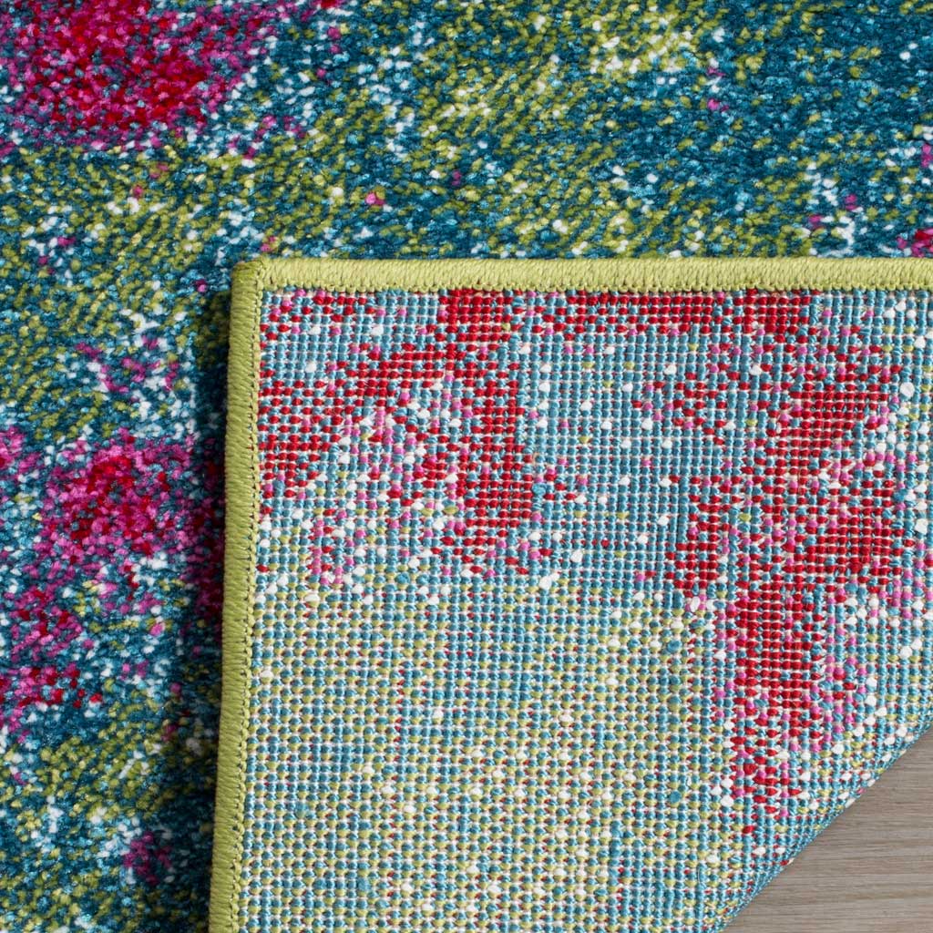 A folded corner reveals tightly woven backing and green edging beneath the rug's vivid pile.