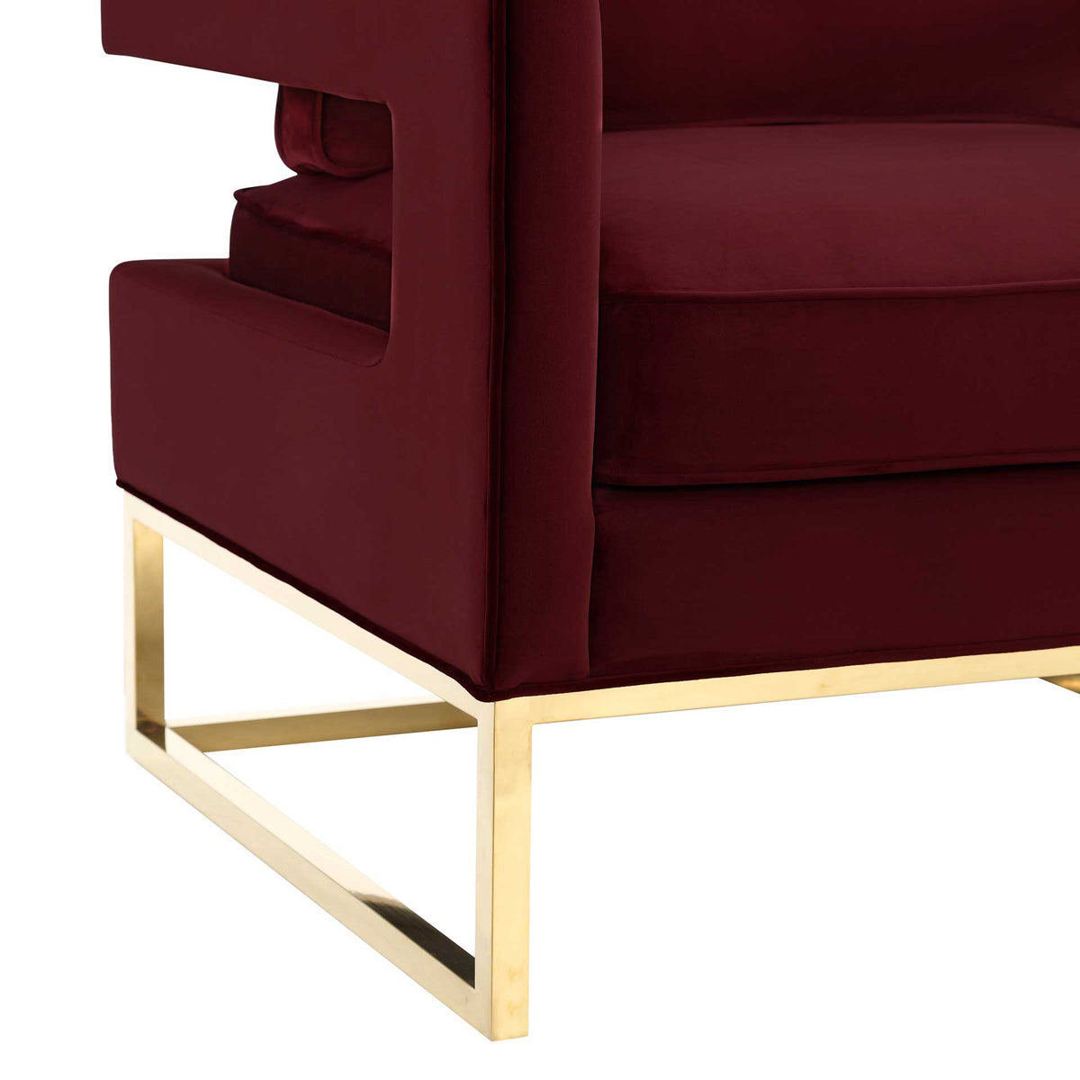 Polished gold stainless steel sled legs create a bold contrast with richly upholstered maroon velvet.