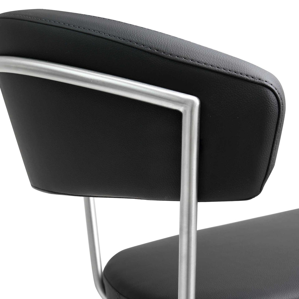 Smooth black upholstery and a crisp stainless steel frame give the curved backrest a refined finish